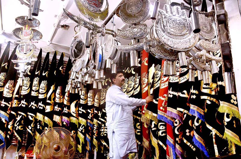 Shopkeeper displays Muharram-ul-Harram related stuff to attract the customer at Bibi Pak Daman