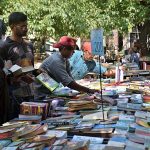 People purchasing used books on a stall at Anarkali in the Provincial Capital.