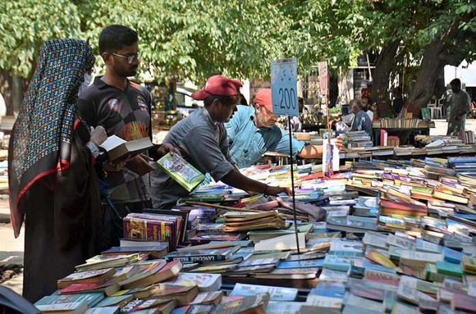 People purchasing used books on a stall at Anarkali in the Provincial Capital.