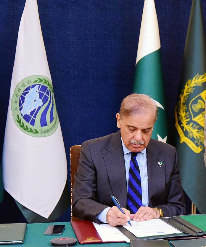 Prime Minister Muhammad Shehbaz Sharif signing Joint Declaration and other documents adopted at the conclusion of the 23rd Shanghai Cooperation Organisation (SCO) Summit held virtually