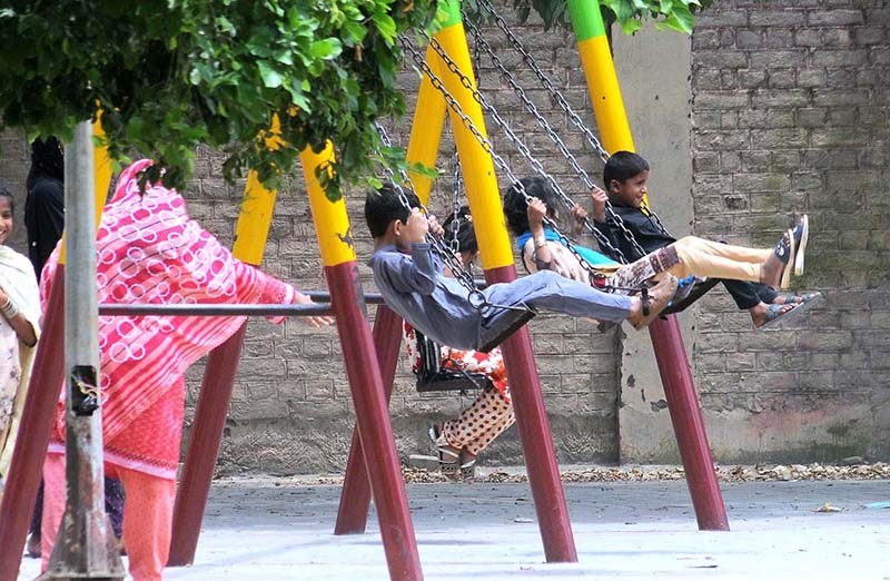 Visitors taking pictures during their visit to Qasim Bagh Park on the 3rd day of Eid ul Adha