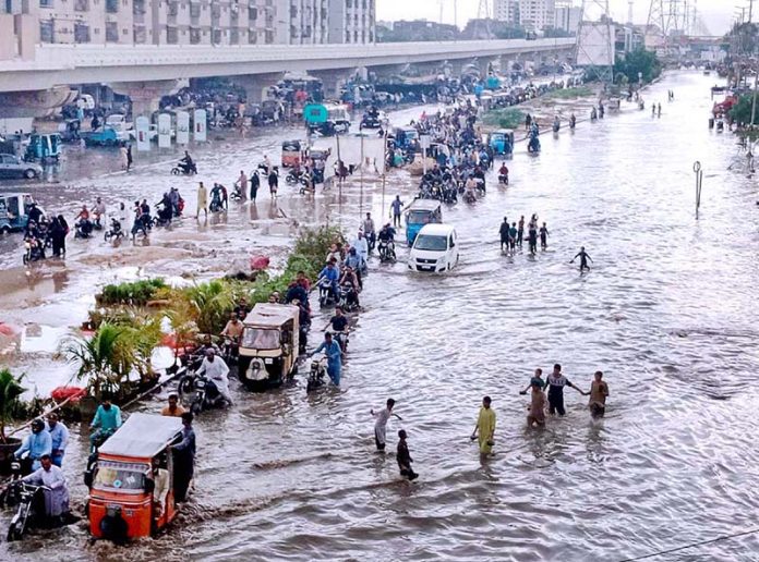 A view of accumulated water on a road after heavy Rain in the Surjani Town area of metropolis