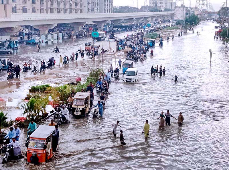 A view of accumulated water on a road after heavy Rain in the Surjani Town area of metropolis