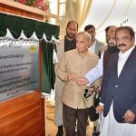 Prime Minister Muhammad Shehbaz Sharif is unveiling the plaque during groundbreaking ceremony for dualization of a road from Faisalabad Bypass to Motorway (M-3) via Satiana