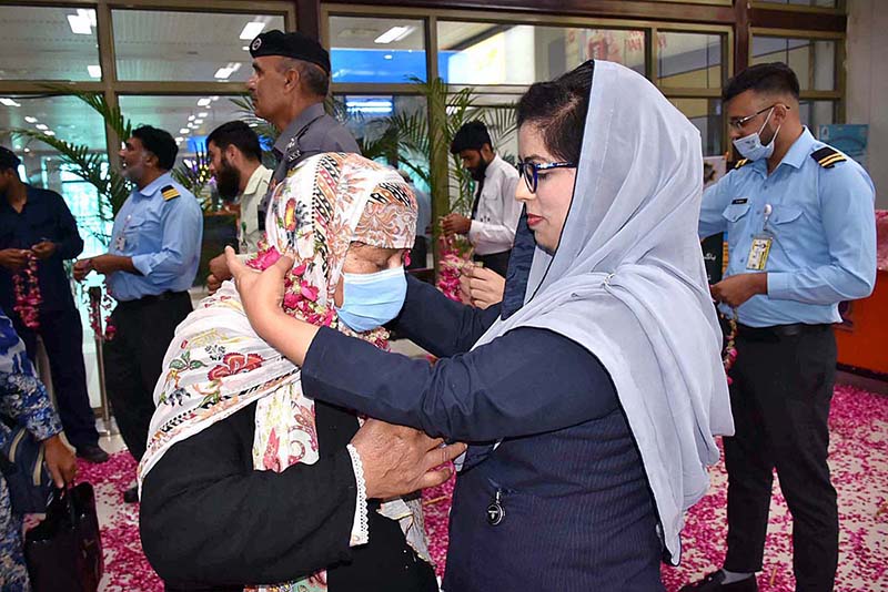 Officers welcoming the pilgrims of the first flight returning after performing the duty of Hajj