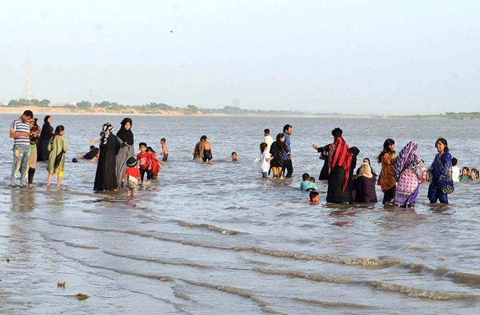 A large number of people enjoying in river water during hot weather in the city