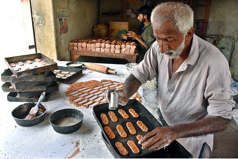 An elder worker busy in work at the a local bakery
