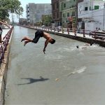 Youngsters diving in the Canal to get some relief from extreme hot weather at Gulbahar area in the city