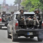 Security officials holding flag march to develop a sense of protection among the masses and maintain law and order situation during the holy month of Muharram ul Haram