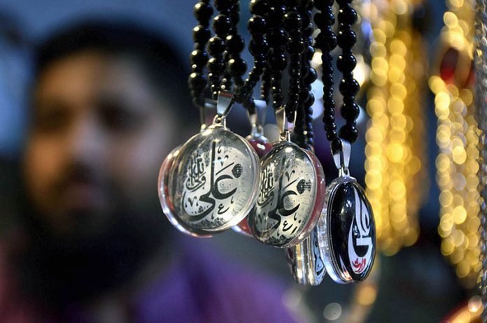 Shopkeeper displays Muharram-ul-Harram related stuff to attract the customer at Bibi Pak Daman