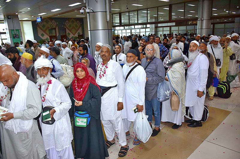 Officers welcoming the pilgrims of the first flight returning after performing the duty of Hajj