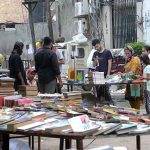 People busy in selecting and purchasing old books from roadside stall in Provincial Capital
