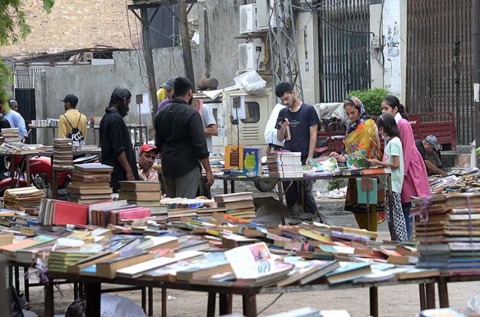 People busy in selecting and purchasing old books from roadside stall in Provincial Capital