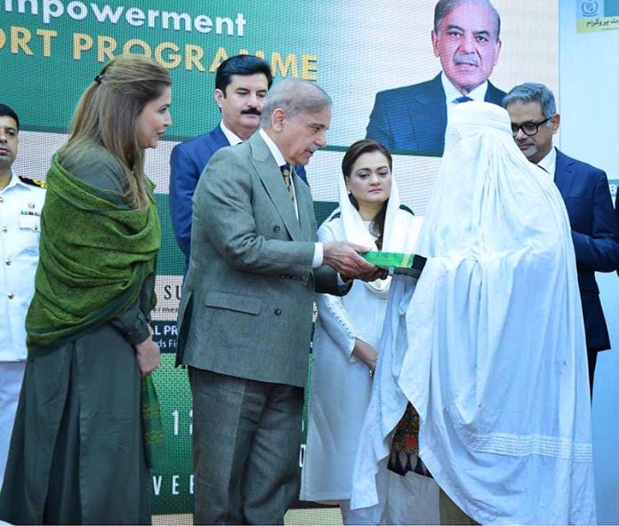 Prime Minister Muhammad Shehbaz Sharif distributing smart cards and cheque books relating to Benazir Social Protection Account among the beneficiaries