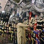 Shopkeeper displays Muharram-ul-Harram related stuff to attract the customer at Bibi Pak Daman