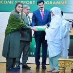 Prime Minister Muhammad Shehbaz Sharif distributing smart cards and cheque books relating to Benazir Social Protection Account among the beneficiaries