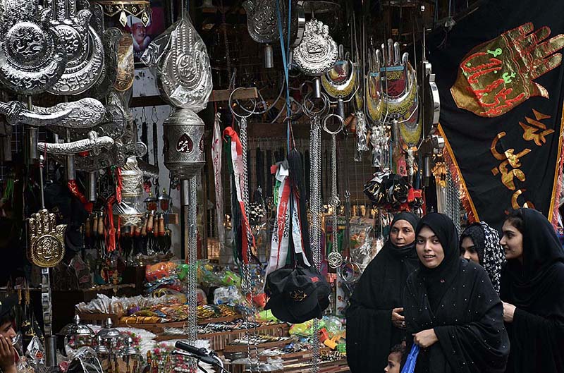 Shopkeeper displays Muharram-ul-Harram related stuff to attract the customer at Bibi Pak Daman