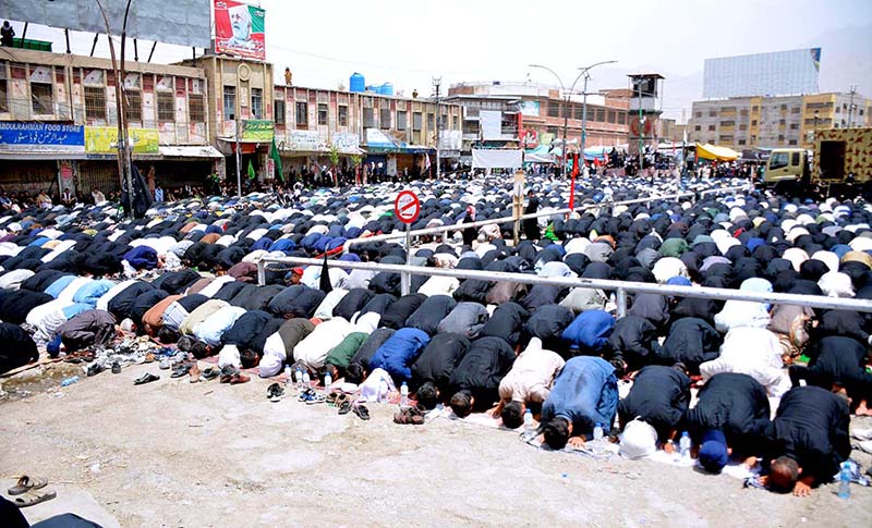 A large number of Shiite Muslims perform Zohrain prayers during the 10th Muharram procession to mark Ashoura at Meezan Chowk. Ashoura is the commemoration marking the Shahadat (death) of Hussein (AS), the grandson of the Prophet Muhammad (PBUH), with his family members during the battle of Karbala for the upright of Islam