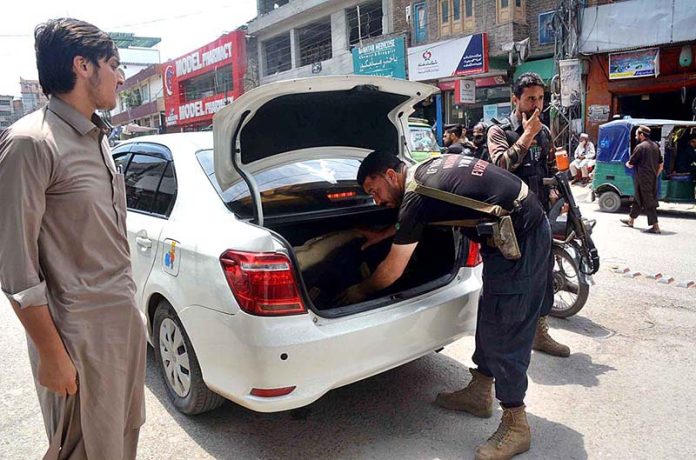Police officials check vehicles at LRH road for security purposes during Ashura