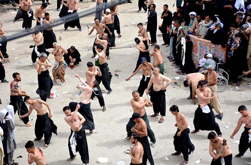 A large number of Shiite Muslims perform Zohrain prayers during the 10th Muharram procession to mark Ashoura at Meezan Chowk. Ashoura is the commemoration marking the Shahadat (death) of Hussein (AS), the grandson of the Prophet Muhammad (PBUH), with his family members during the battle of Karbala for the upright of Islam