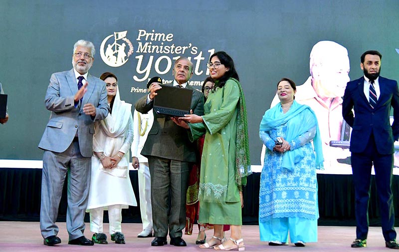 Prime Minister Muhammad Shehbaz Sharif distributing laptops among high achievers of public sector university students under the Prime Minister's Youth Laptop Scheme