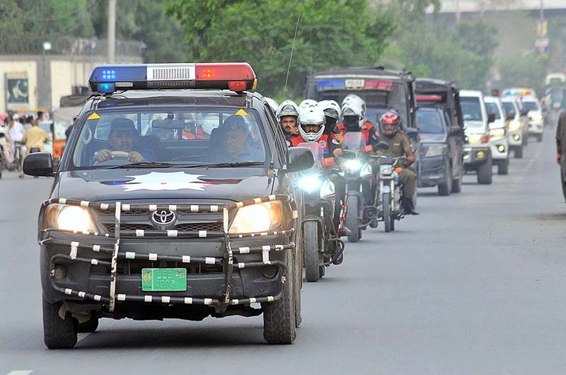 Police officials holding a flag march to develop a sense of protection among the masses and maintain law and order situation during the holy month of Muharram ul Haram