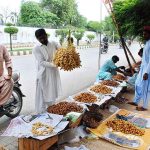 A vendor selling dates at his roadside setup in the city