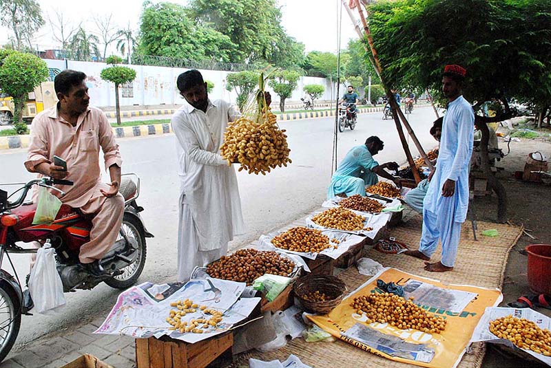 A vendor selling dates at his roadside setup in the city