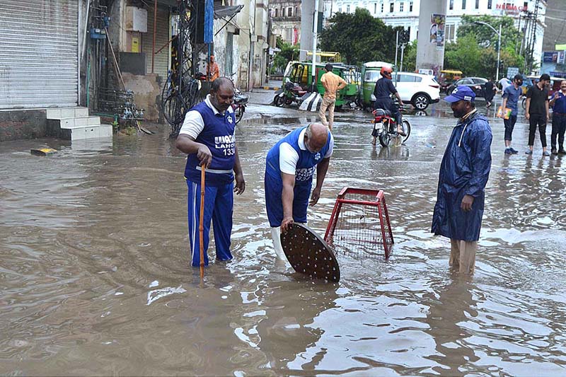 People throng at a samosa shop after heavy rains in the city