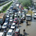 A massive traffic jam near Kalma Chowk due to rain water accumulated on Feroz pur Road underpass during rain that experienced in the city