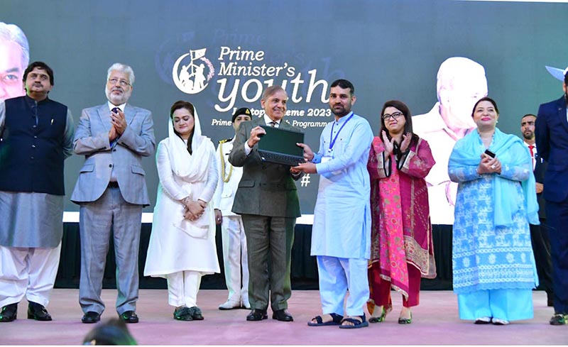 Prime Minister Muhammad Shehbaz Sharif distributing laptops among high achievers of public sector university students under the Prime Minister's Youth Laptop Scheme