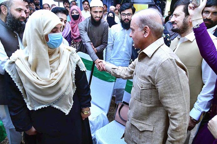Prime Minister Muhammad Shehbaz Sharif interacts with students at the ceremony of merit-based distribution of laptops among high-achieving students under the Prime Minister's Youth Laptop Scheme 2023