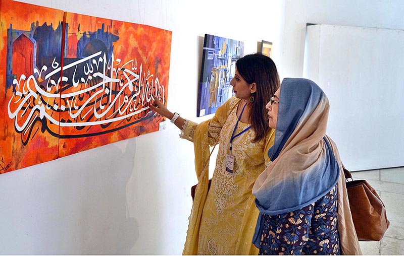 Visitors keenly viewing the artwork by children of Pakistan Institute for Deaf and Disabled during art exhibition titled “Silent Expression” at Al Hamra Art Gallery