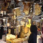 Women selecting and purchasing Muharram-ul-Harram related stuff displaying from shopkeeper at Bibi Pak Daman