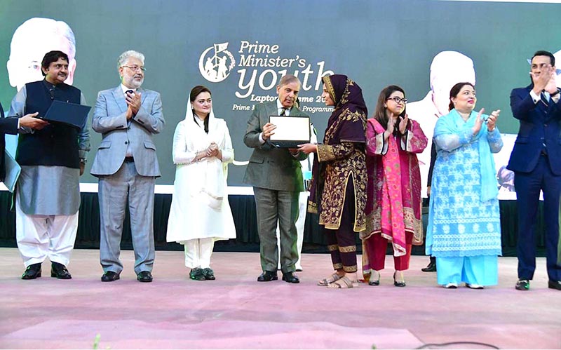 Prime Minister Muhammad Shehbaz Sharif distributing laptops among high achievers of public sector university students under the Prime Minister's Youth Laptop Scheme