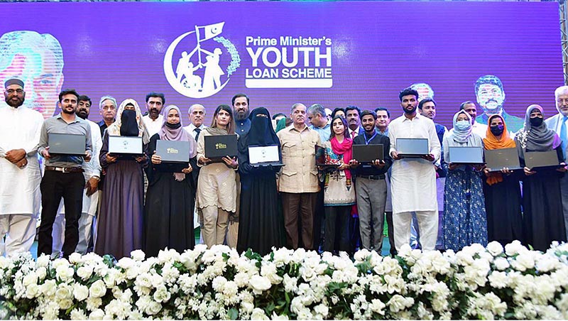 Prime Minister Muhammad Shehbaz Sharif in a group photo with high achievers who received laptops under the PM's Youth Laptop Scheme at Bahauddin Zakaria University