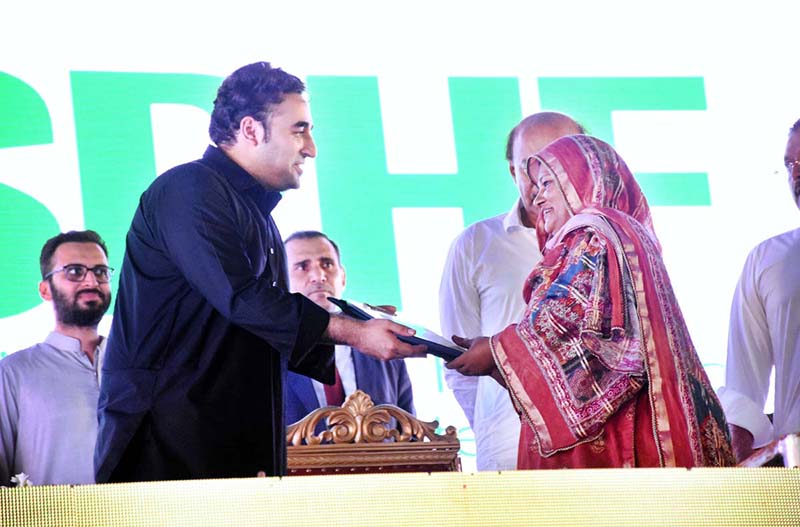 Chairman PPP and Foreign Minister Bilawal Bhutto Zardari handing over the land titles to flood affectees people in a ceremony at Dhamra Village