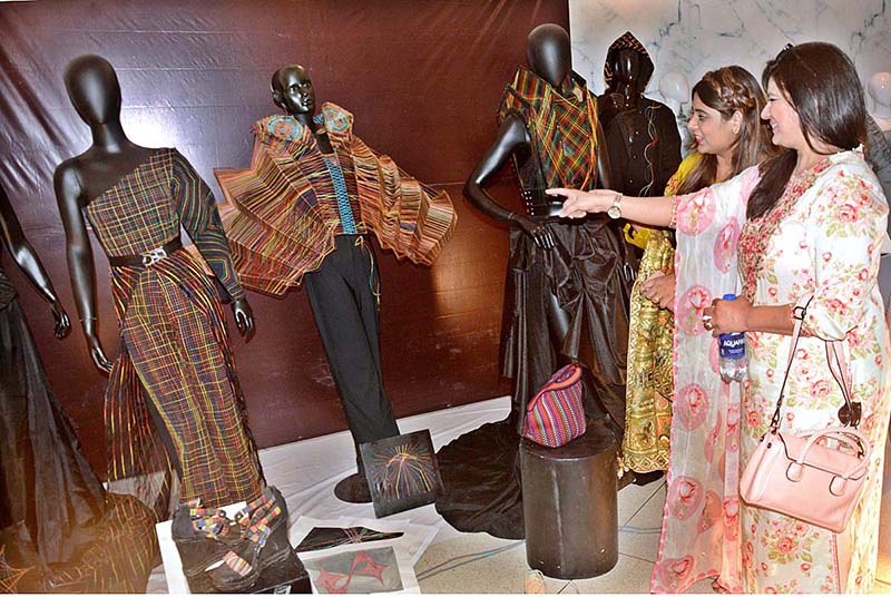 Visitors watching artworks during students of Textiles, Fashion & Interior Design, university of South Asia Al Hamra Hall