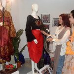 Visitors viewing the displayed stuff during Student Textile Design Degree Show organized by Lahore College for Women at Alhamra Art Gallery