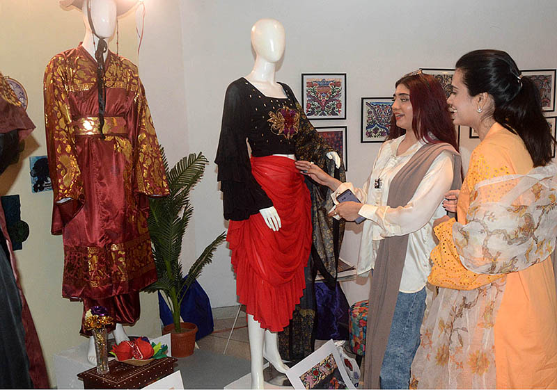 Visitors viewing the displayed stuff during Student Textile Design Degree Show organized by Lahore College for Women at Alhamra Art Gallery