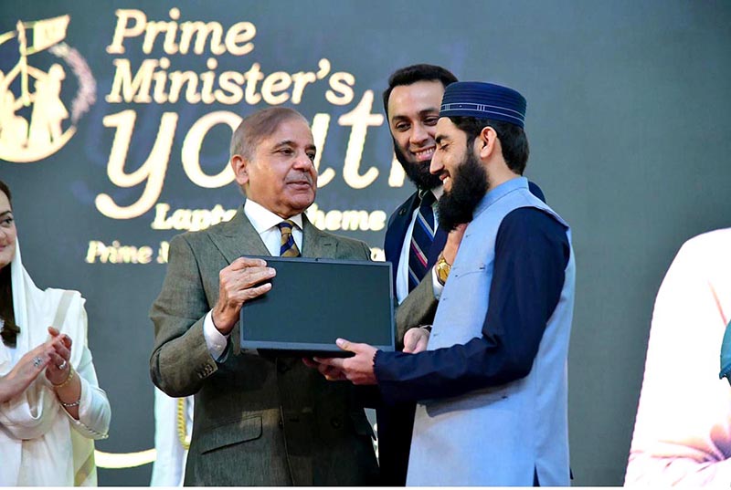 Prime Minister Muhammad Shehbaz Sharif distributing laptops among high achievers of public sector university students under the Prime Minister's Youth Laptop Scheme