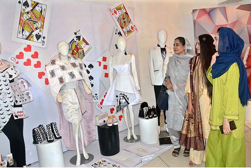 Visitors watching artworks during students of Textiles, Fashion & Interior Design, university of South Asia Al Hamra Hall