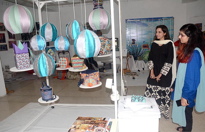 Visitors viewing the displayed stuff during Student Textile Design Degree Show organized by Lahore College for Women at Alhamra Art Gallery