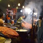 A vendor preparing traditional food item (Katlama) at Syed Mauj Darya Road
