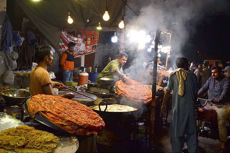 A vendor preparing traditional food item (Katlama) at Syed Mauj Darya Road