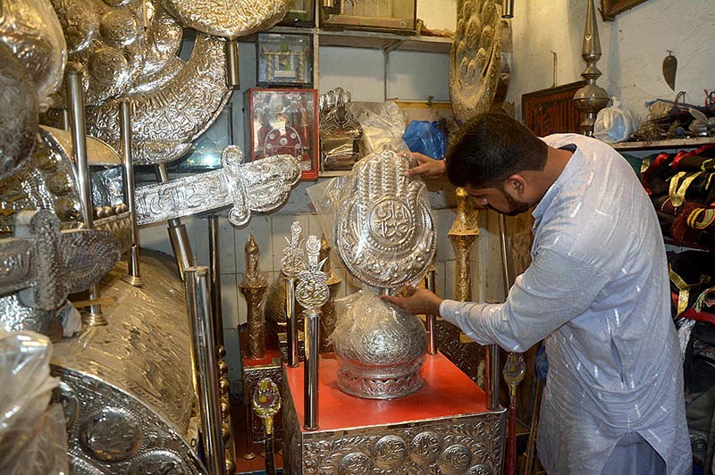 A worker preparing Moharam ul Haram related stuff at his workplace