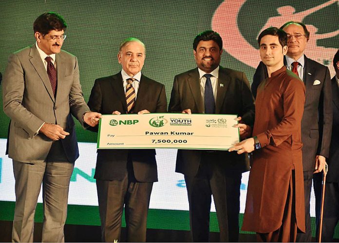 Prime Minister Muhammad Shehbaz Sharif distributing cheques among the recipients of Prime Minister’s Youth Business and Agriculture Loan Scheme at the Sindh Governor House