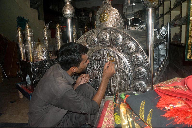 A worker preparing Moharam ul Haram related stuff at his workplace