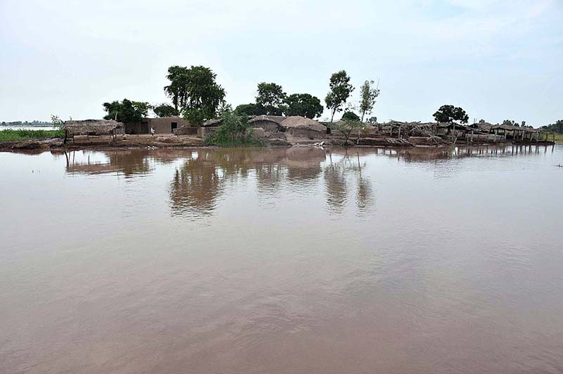 People cross flood water on a boat after river Ravi water entered in their houses at Village Naul Manga Mandi 30 Kilometer from the Provincial Capital