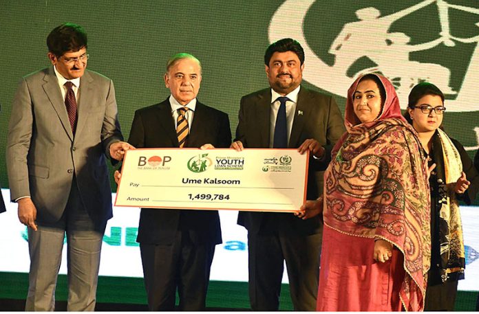 Prime Minister Muhammad Shehbaz Sharif distributing cheques among the recipients of Prime Minister’s Youth Business and Agriculture Loan Scheme at the Sindh Governor House